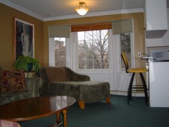 Main floor Family room with sunny bay window open to the Kitchen 